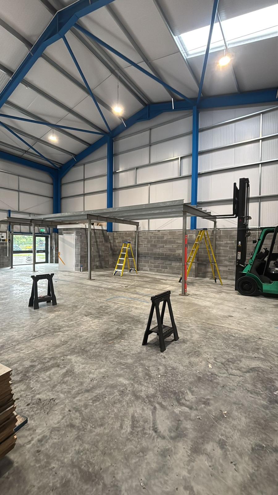 Steel mezzanine frame erected inside an empty commercial unit